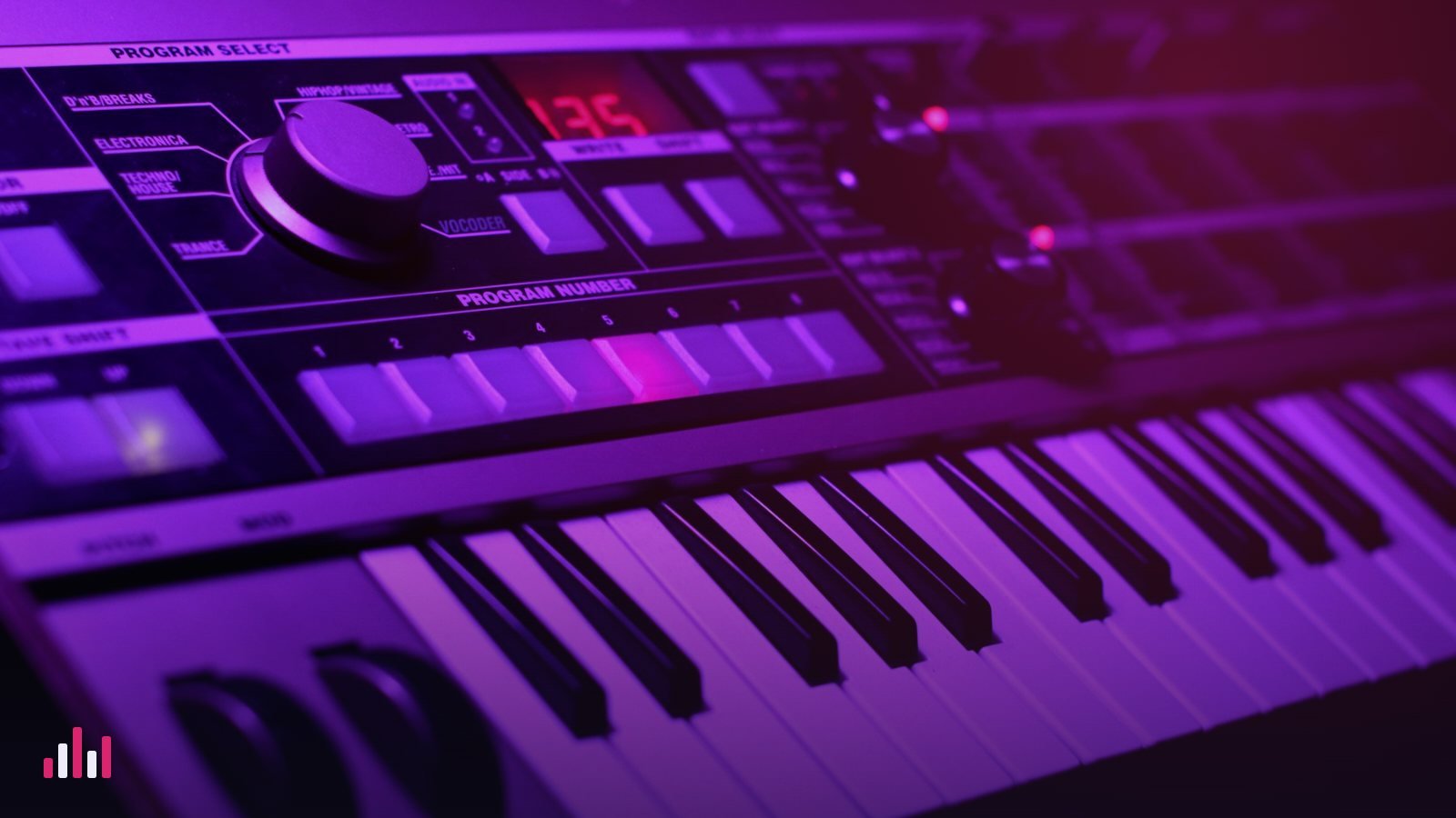 A synthesizer keyboard glowing under purple light